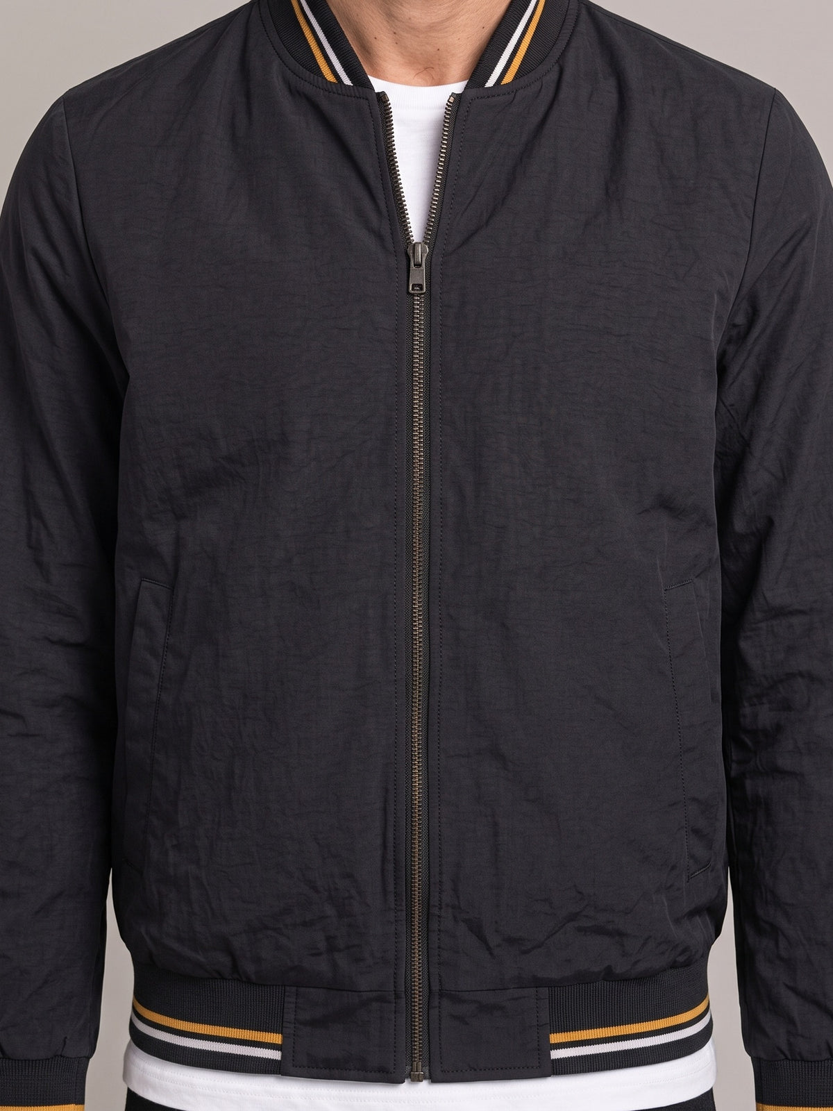 Detalle del cuello de punto y la cremallera de la chaqueta bomber ÁNGEL IGNACIO
